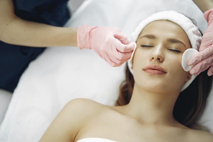 a beauty therapist working on skincare for a client