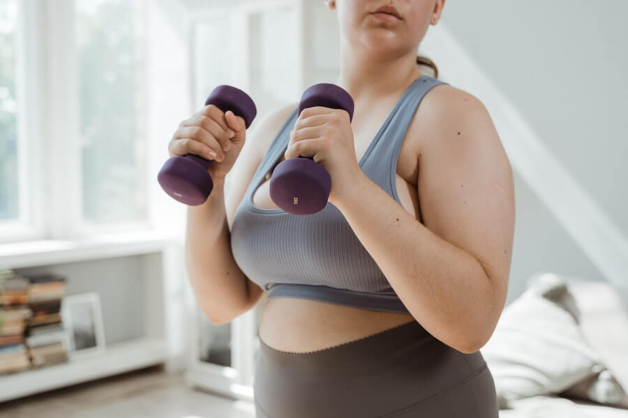 woman using hand weights to exercise