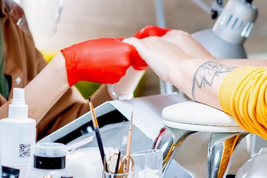 a beautician working on a clients nails