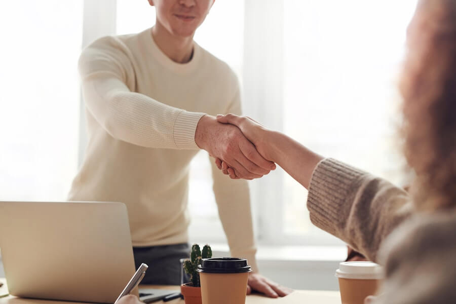 people at job interview shaking hands after a successful interview