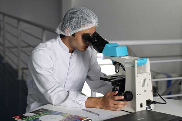 Scientist looking through a microscope