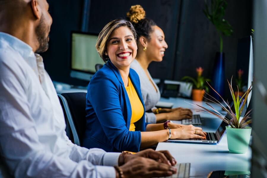 smiling employees with boosted employee productivity