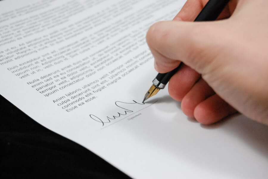 someone adding their signature to their type of employment contract 