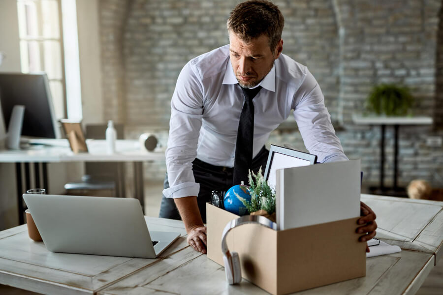 office worker packing up belongings after working his notice period