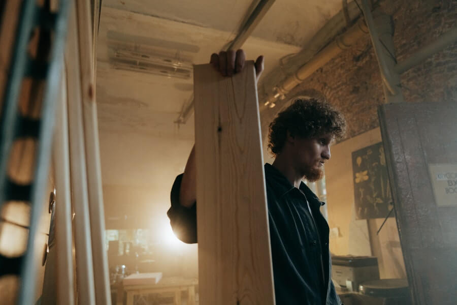 Man carrying a plank of wood