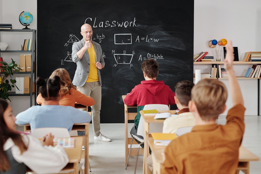 a teacher asking a question in a classroom