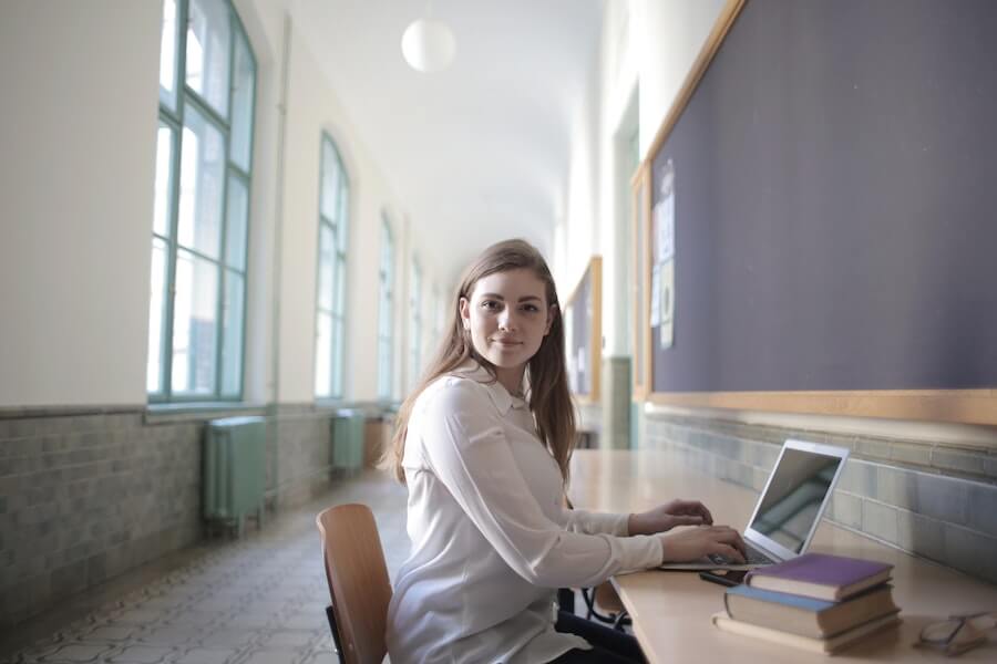 woman on laptop working towards university qualification