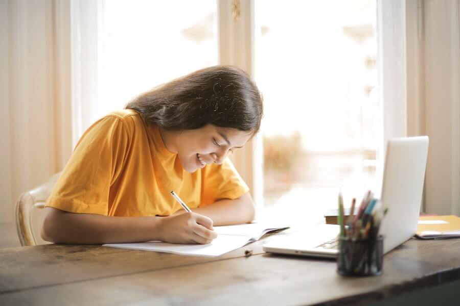 happy woman revising at desk