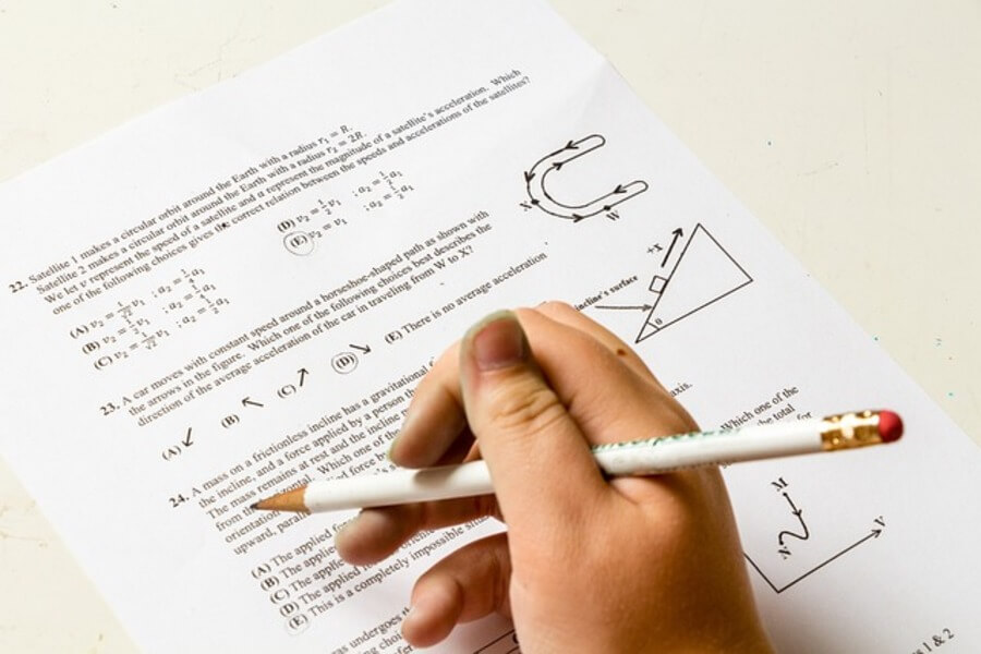 person completing a gcse exam paper