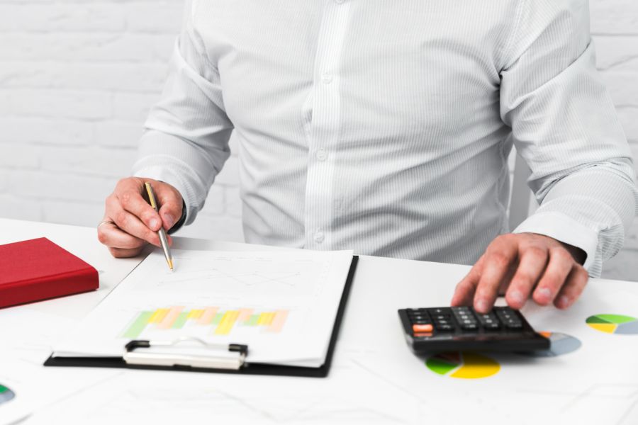 Man using a calculator to work out his redundancy package