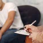 man sitting in psychologists office in a session