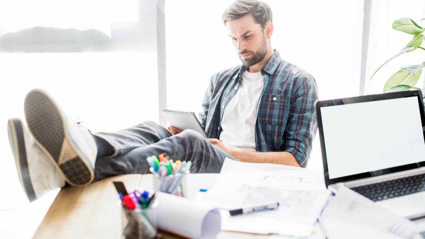 man at work in an office avoiding work
