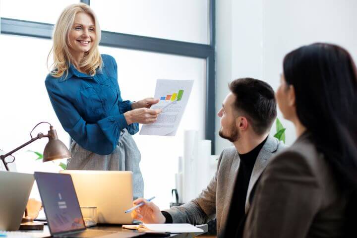 business manager presenting to employees showing career opportunities in business management