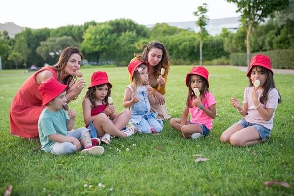 Childminders looking after children whilst eating ice cream