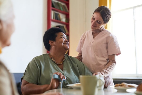 social worker chatting to elderly black women